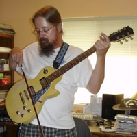 Lonny Balderston bowing his guitar.